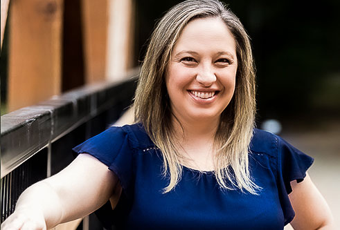 Dr. Nikki Stillo standing in front of an outdoor background.